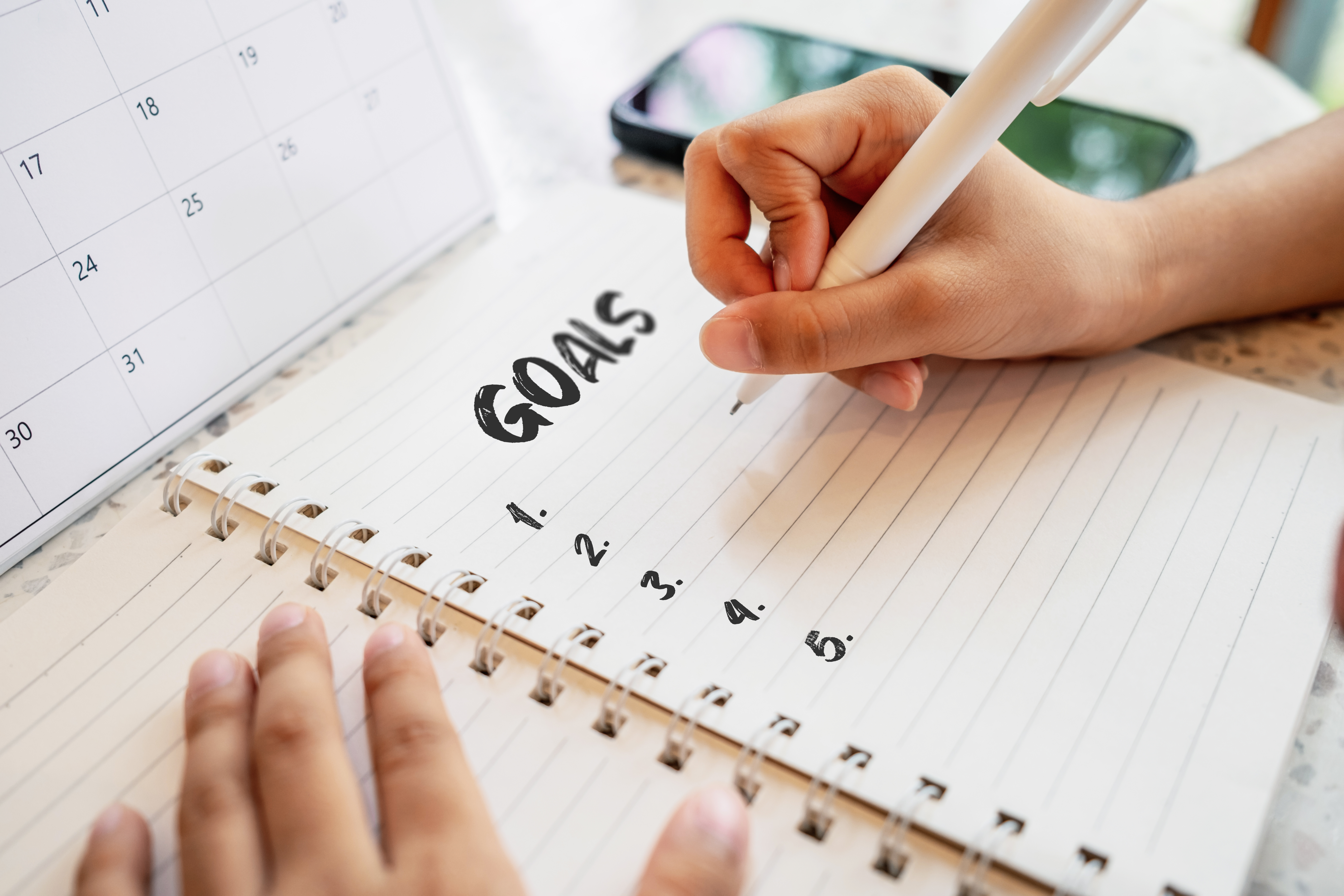 open notebook with goals written in black ink